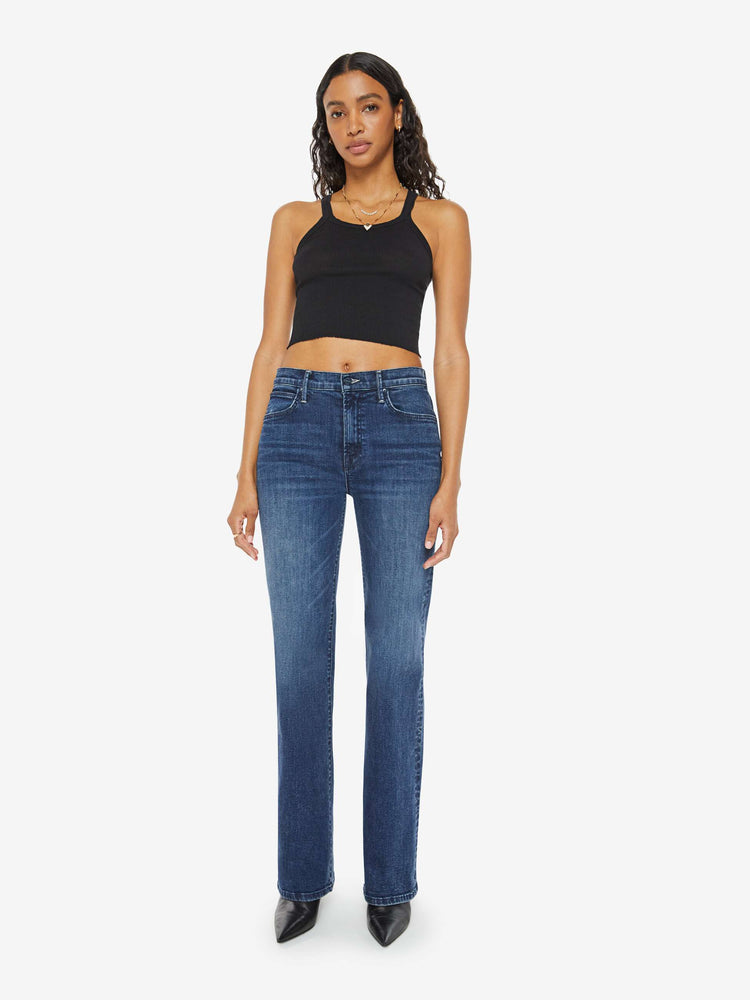 Front view of a woman in a dark blue high-rise straight leg jean with a 30-inch inseam and a clean hem.