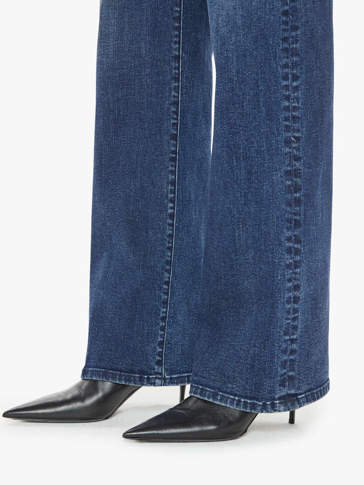 Hem close up view of a woman in a dark blue high-rise straight leg jean with a 30-inch inseam and a clean hem.