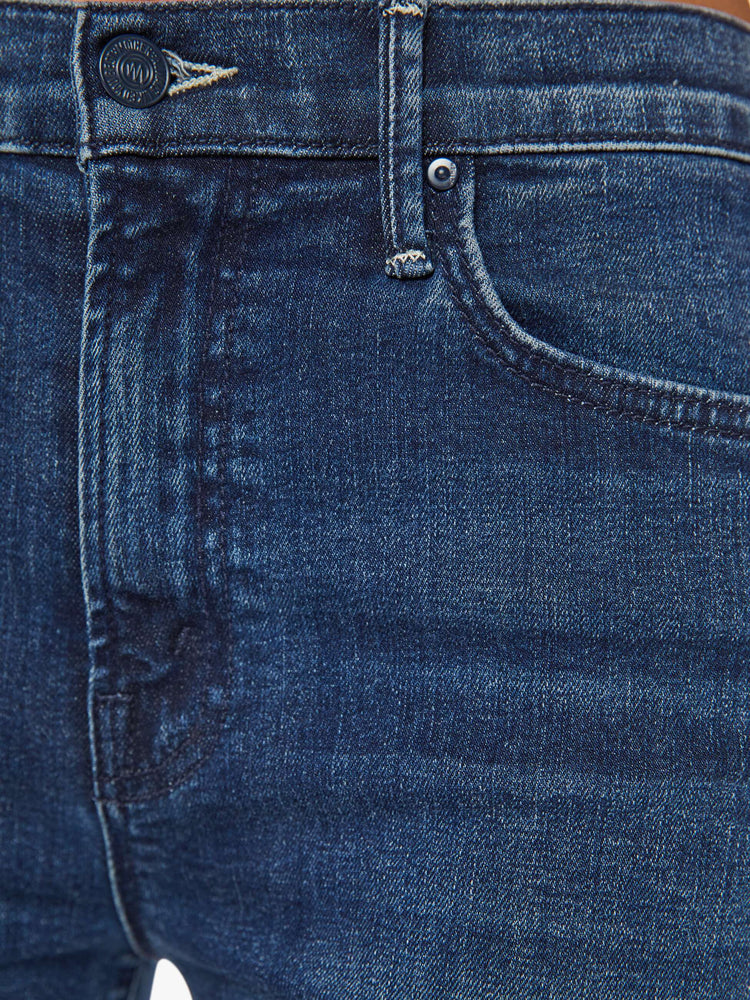 Swatch view of a woman in a dark blue high-rise straight leg jean with a 30-inch inseam and a clean hem.