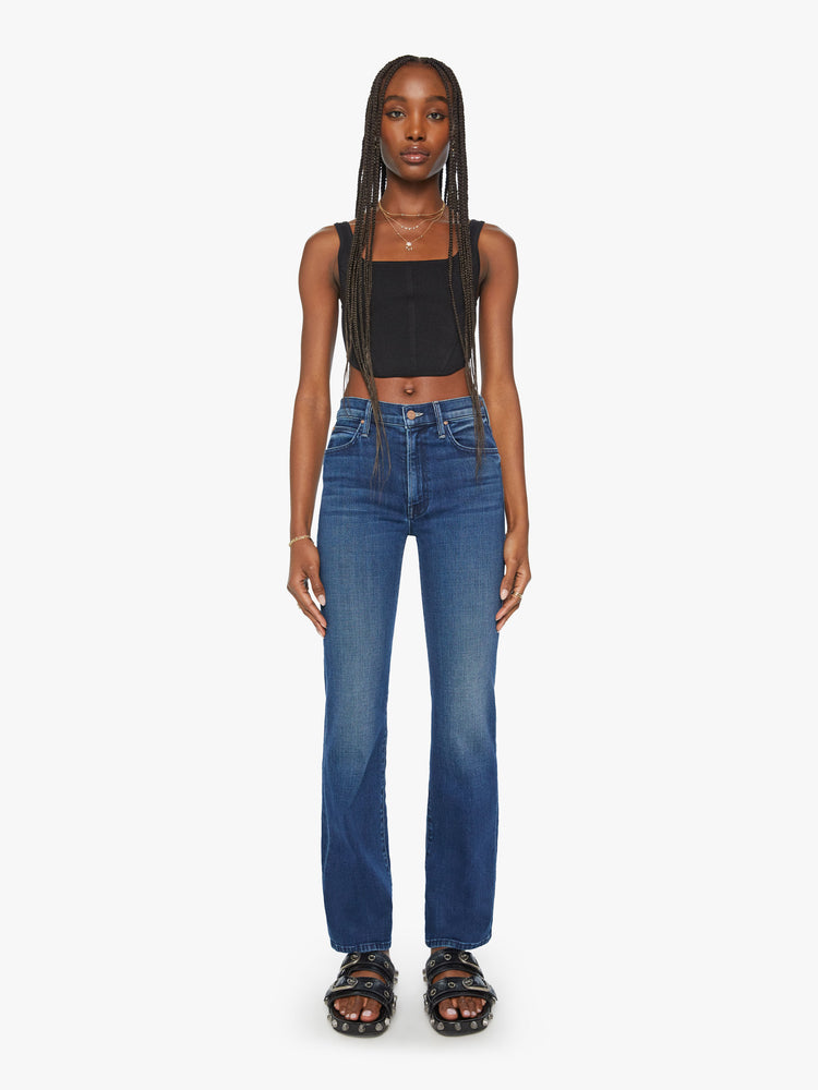 Front view of a woman dark blue high-waisted bootcut with a 32-inch inseam and a clean hem.