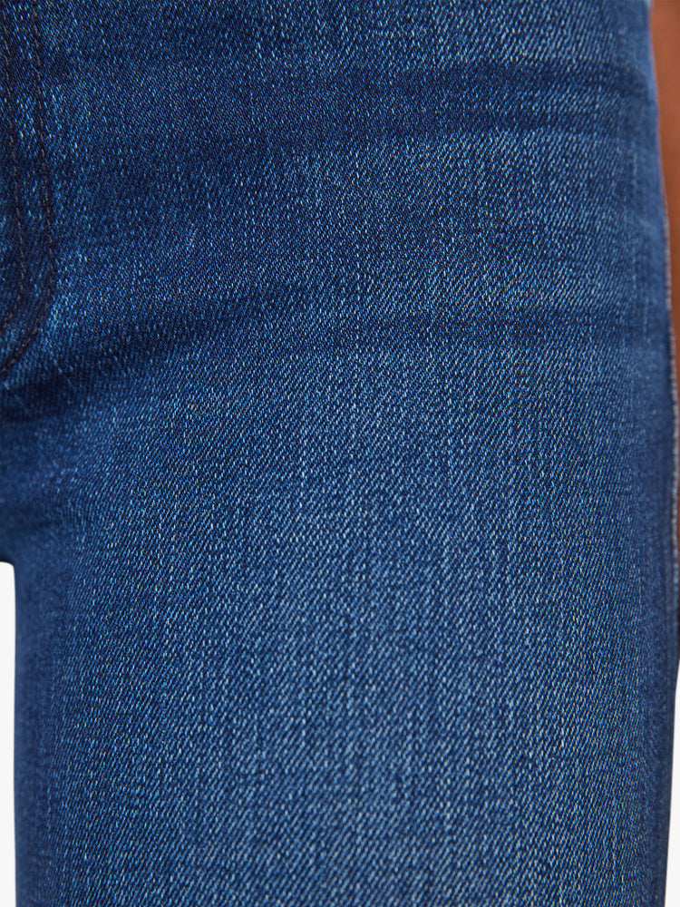Swatch view of a woman dark blue high-waisted bootcut with a 32-inch inseam and a clean hem.