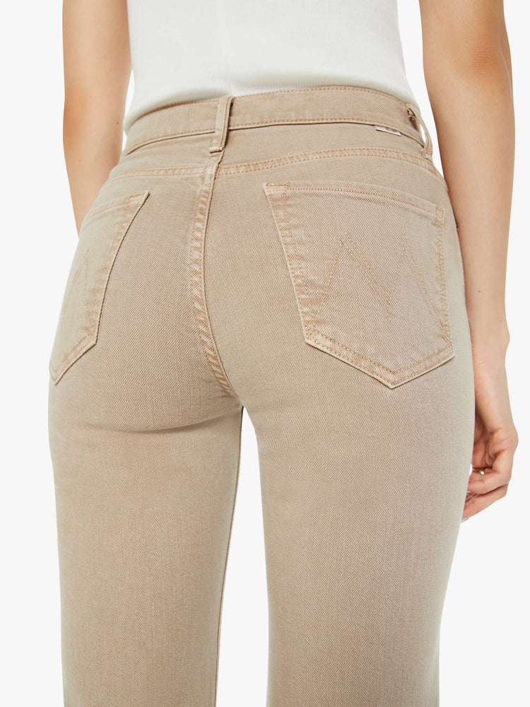 Back view of a woman in a light khaki high-rise straight leg with a 32-inch inseam and a clean hem.