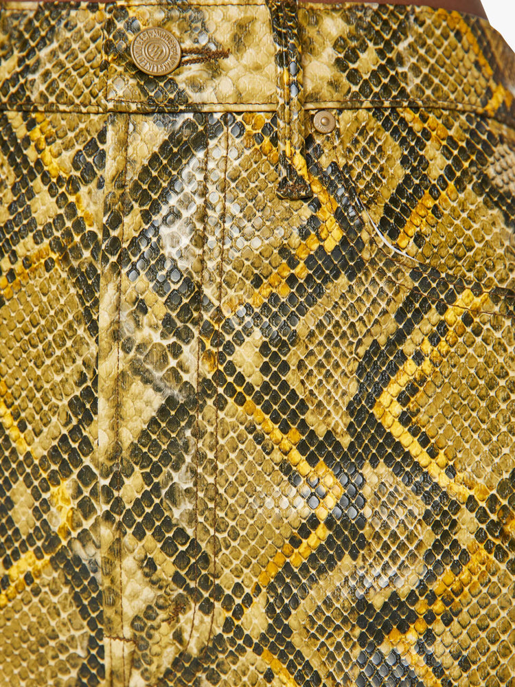 Swatch view of a woman in a yellow and black faux snakeskin super high-waisted pants with a flared leg and a long 34-inch inseam with a clean hem.