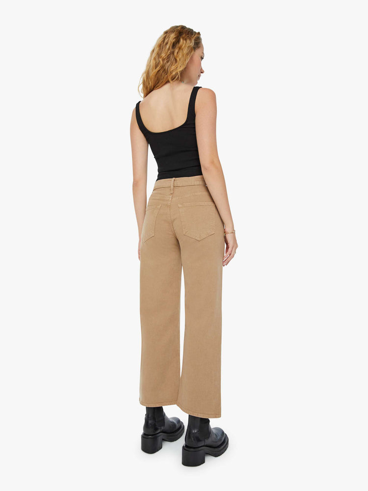 Back view of a woman in dark khaki lower rise pants with a loose straight leg and a 28.25-inch inseam with a clean hem.