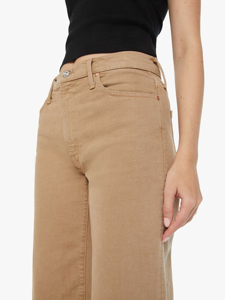 Swatch view of a woman in dark khaki lower rise pants with a loose straight leg and a 28.25-inch inseam with a clean hem.