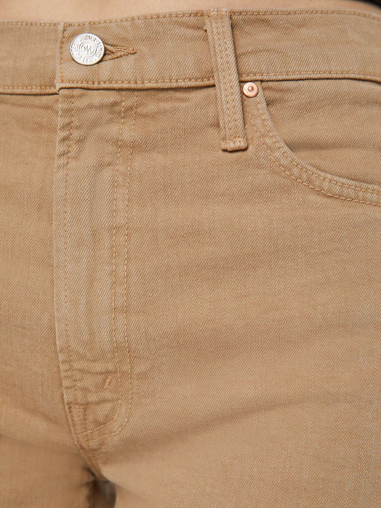 Detailed view of a woman in dark khaki lower rise pants with a loose straight leg and a 28.25-inch inseam with a clean hem.