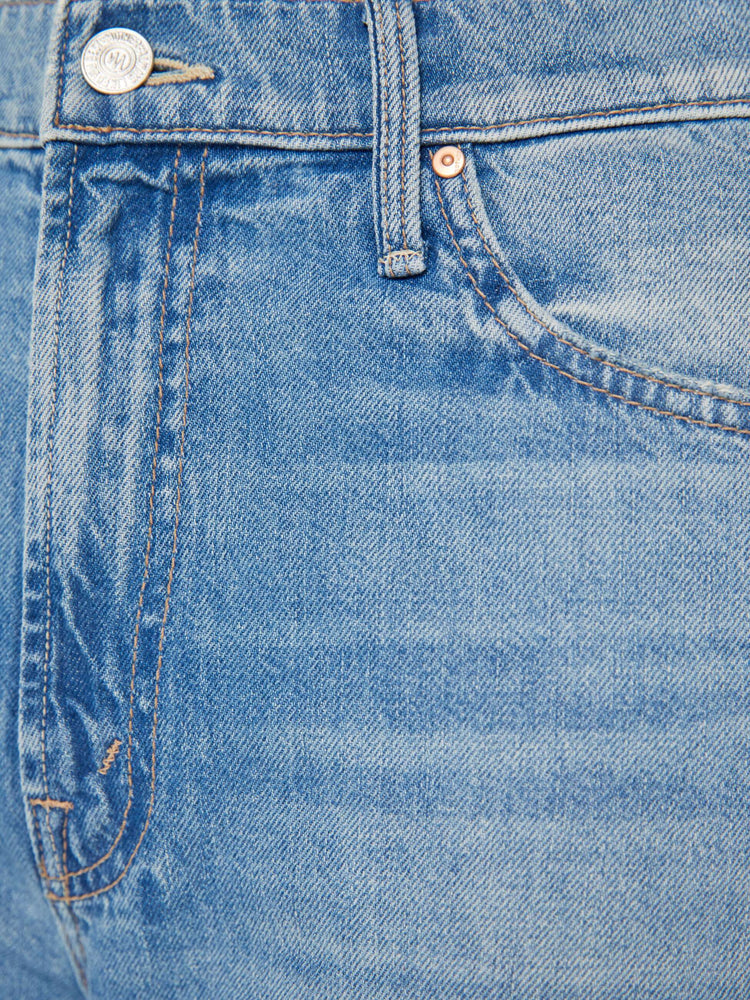 Swatch view of a woman in light blue denim set to sit lower on the hips with a loose straight left and clean hem.