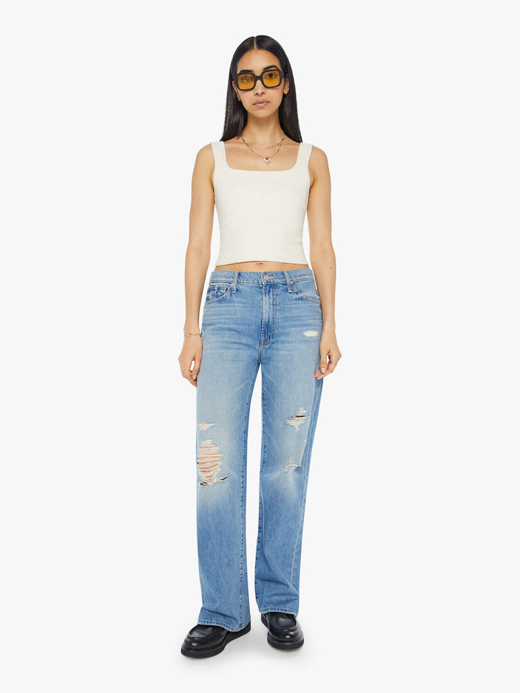 Front view of light blue jeans set to sit lower on the hips with a loose straight leg.