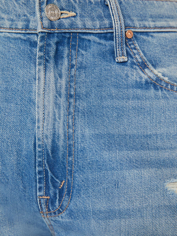 Swatch view of light blue jeans set to sit lower on the hips with a loose straight leg.