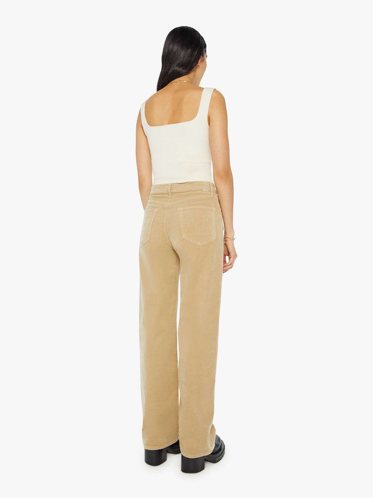 Back view of a woman in a light khaki corduroy loose straight leg jean with a 32-inch inseam.