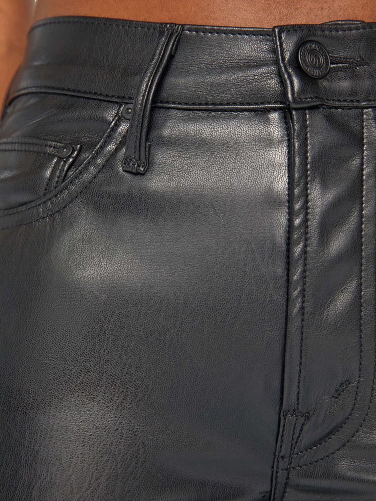 Swatch view of a woman black faux leather high-rise bootcut has a 28.25-inch inseam and a clean hem.