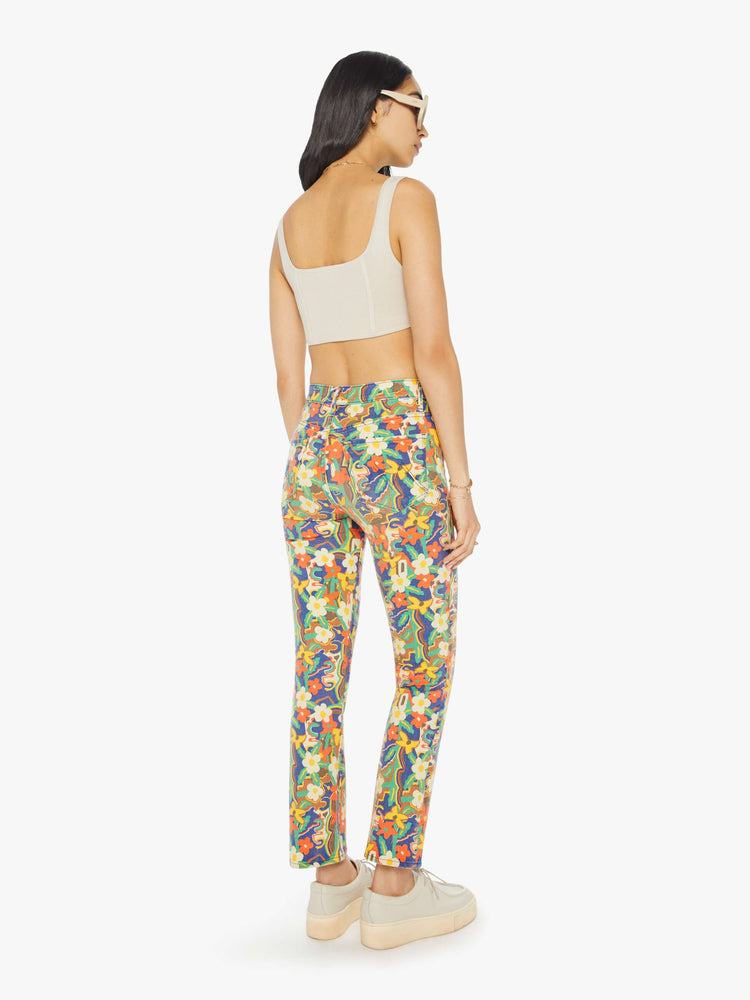 Back view of a woman in colorful floral print high-rise bootcut pants with a clean hem.