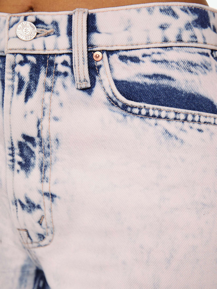 swatch view of jeans that are acid-washed and overdyed in a soft light pink with darker spots throughout.