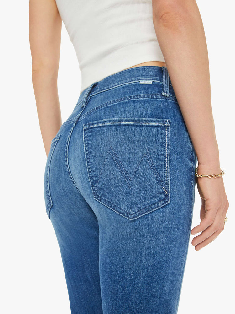 Close up view of a mid-rise straight-leg jeans with an ankle-length inseam and a clean hem. 