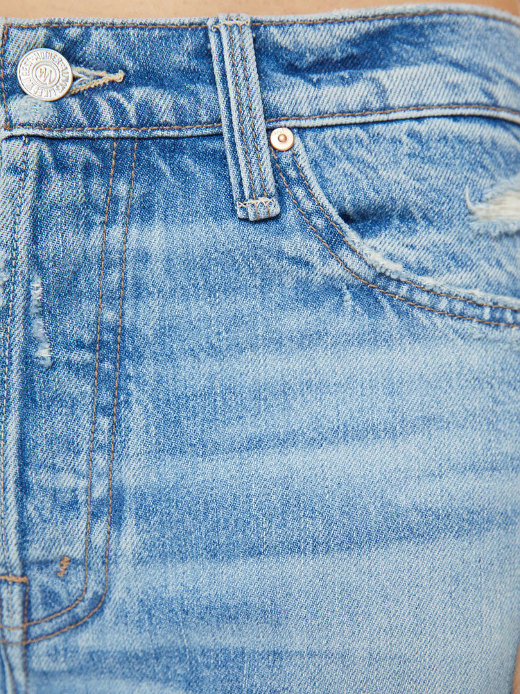 Swatch view of the woman in a mid blue wide-leg jeans feature a button fly, low-set back pockets, mid rise with a slightly dropped crotch and a 32-inch inseam. 