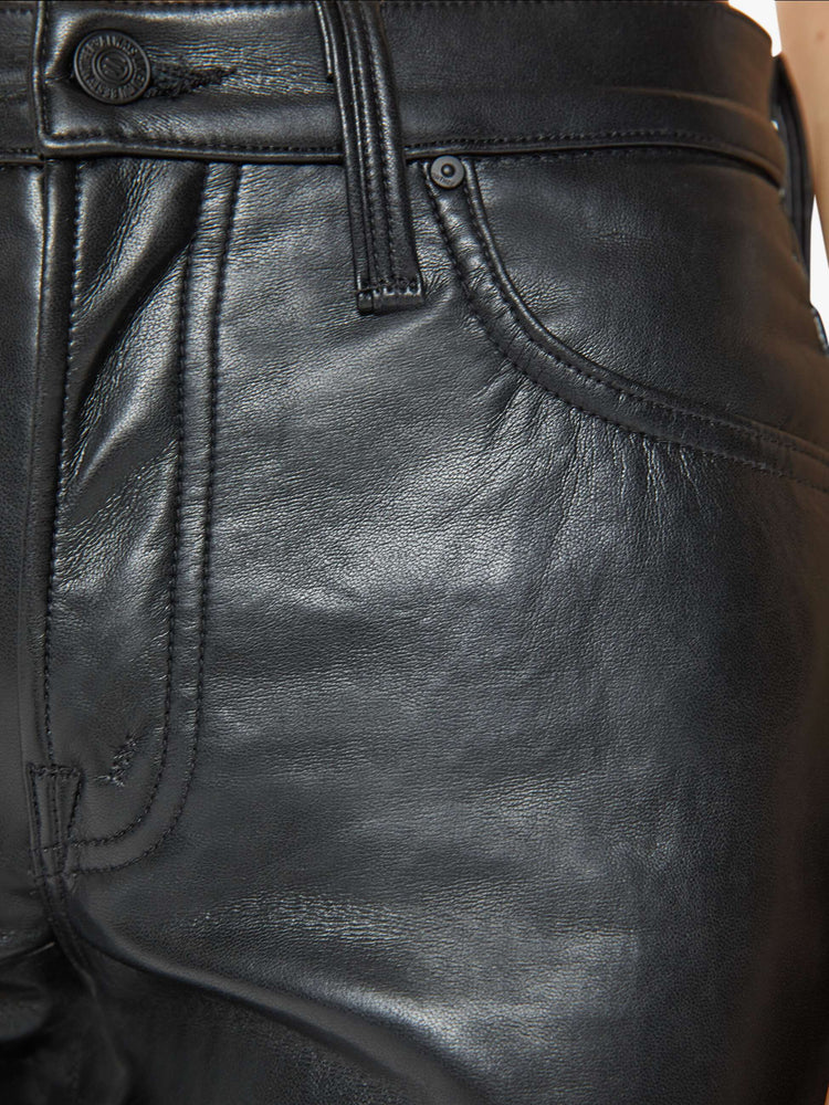 Swatch view of a woman in a recycled black leather high waisted straight-leg pants with a 31-inch inseam and a clean hem.