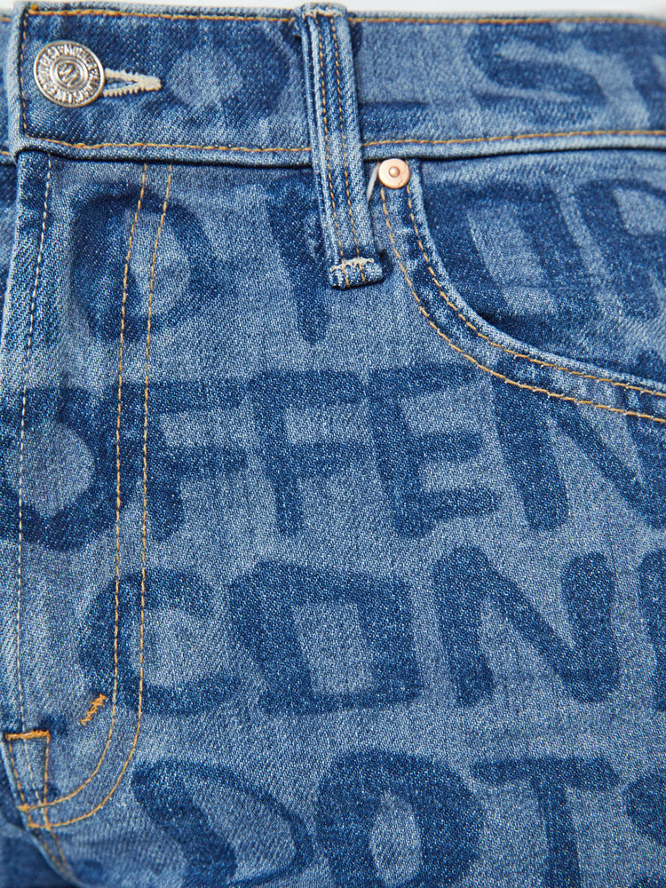 Swatch view of a woman in a high waisted straight-leg jeans with a 31-inch inseam and a clean hem in a mid blue wash with laser-processed text in dark blue throughout.