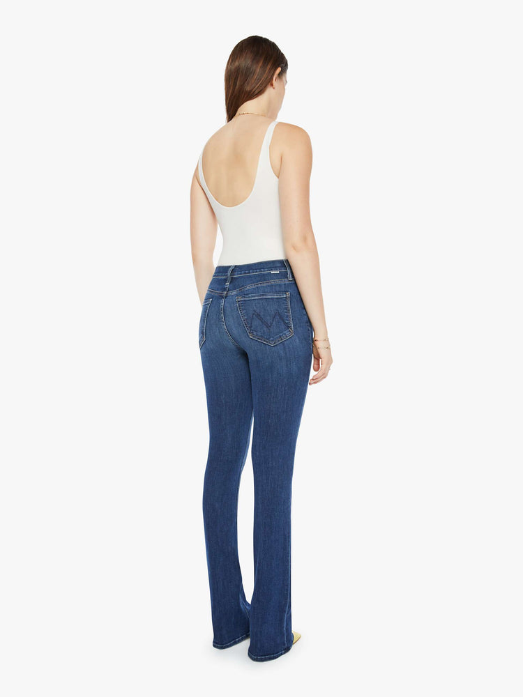 Back view of a dark blue wash denim skinny flare featuring a high rise.