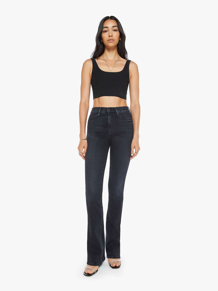 Front view of a womens high rise flare jean featuring a dark black wash and a clean hem.