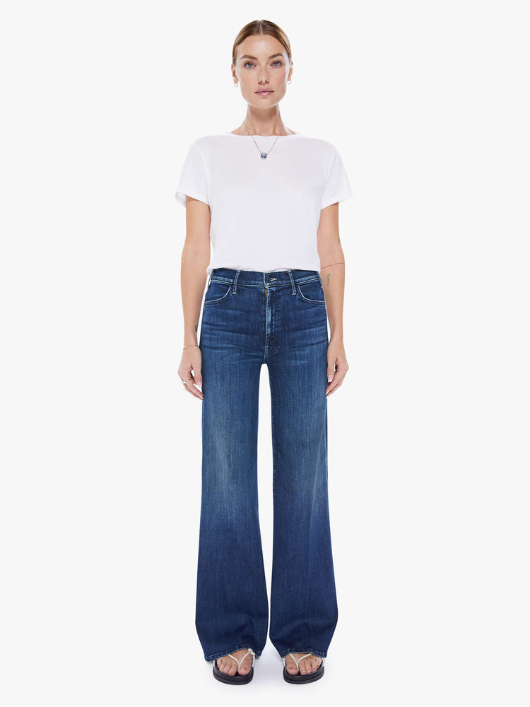 Front view of a woman wide leg jeans with a high rise, 32-inch inseam and a clean hem in a dark blue wash.