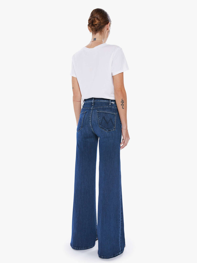 Back view of a woman wide leg jeans with a high rise, 32-inch inseam and a clean hem in a dark blue wash.