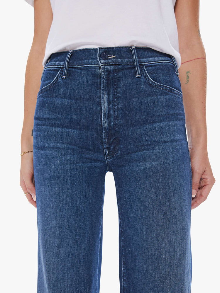 Front close up view of a woman wide leg jeans with a high rise, 32-inch inseam and a clean hem in a dark blue wash.