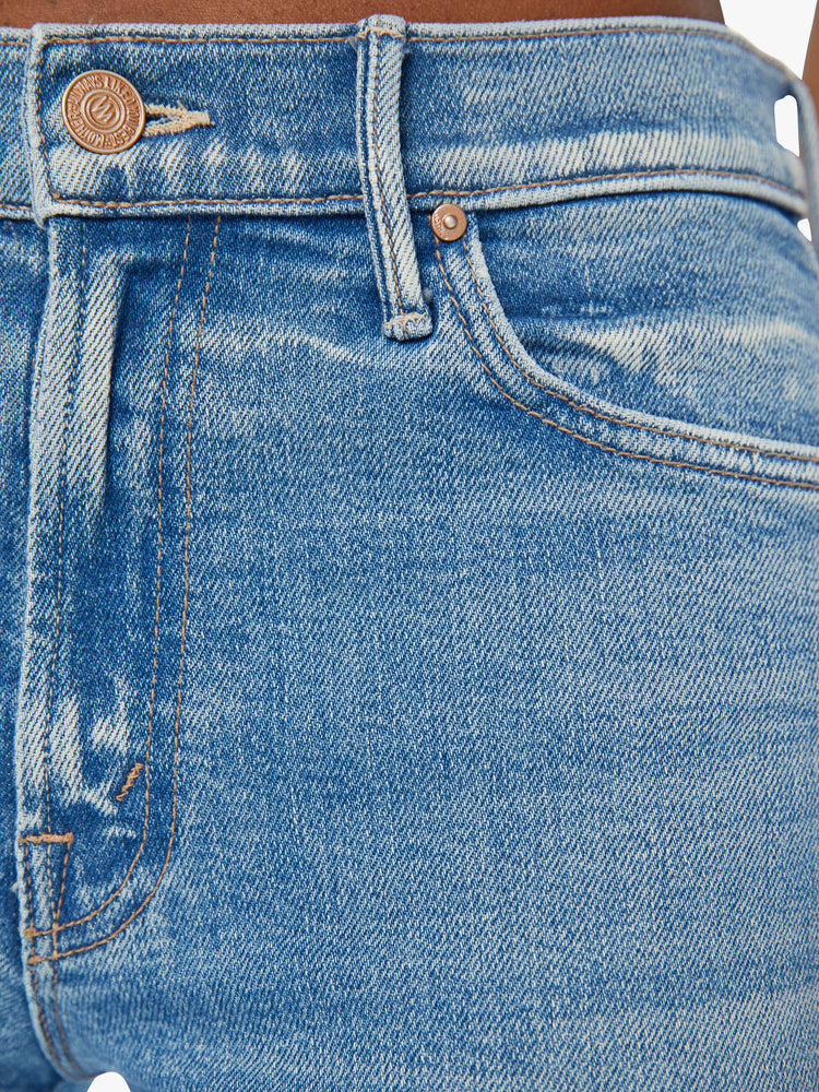 Swatch view of a woman in mid rise flare jean in a light blue wash. 