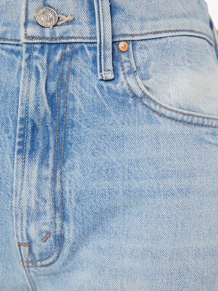 Swatch view of a high rise wide leg jean in a light blue wash with printed pattern down the side of each leg.