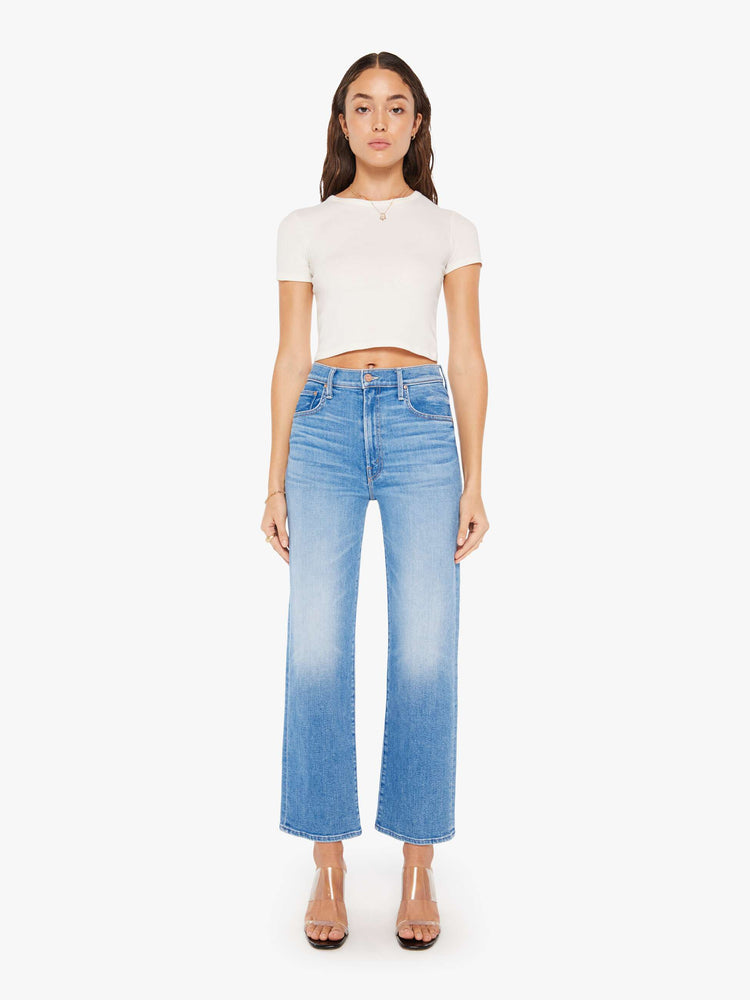 Front view of a woman high-waisted jean with a wide straight leg, zip fly and clean 28.25-inch inseam in a mid blue wash.