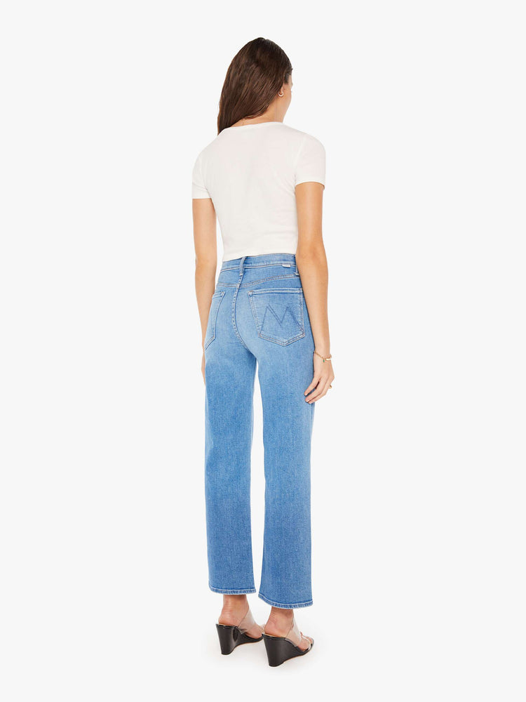 Back view of a woman high-waisted jean with a wide straight leg, zip fly and clean 28.25-inch inseam in a mid blue wash.