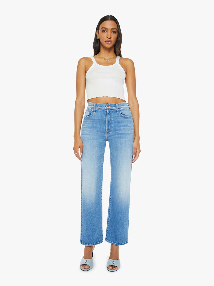 Front view of a woman medium blue wash high-waisted jeans with a wide straight leg, zip fly and clean 28.25-inch inseam.