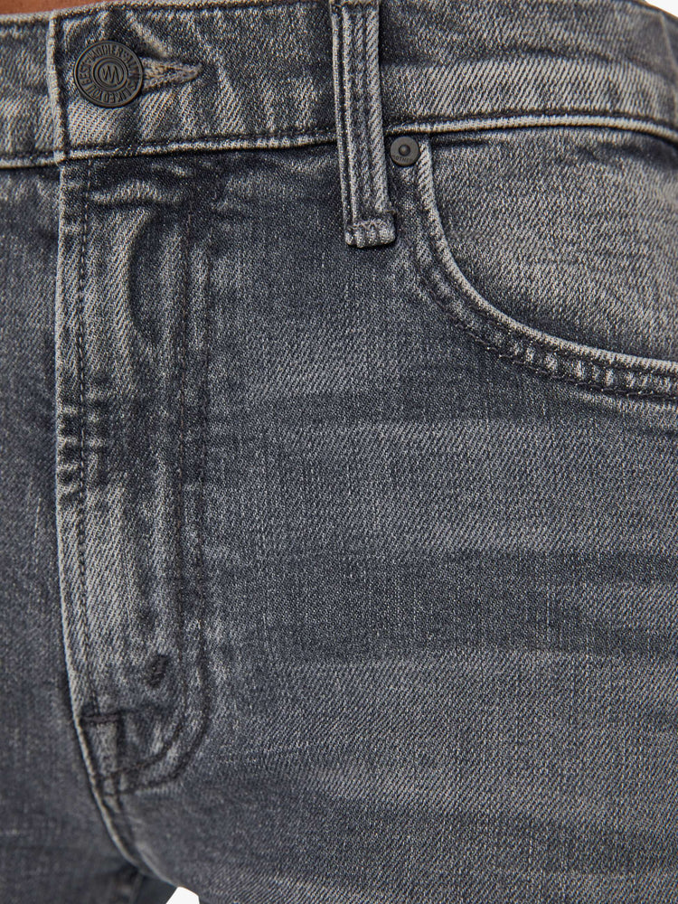 Front swatch view of a woman in mid-rise dark grey straight leg jeans with a clean hem.