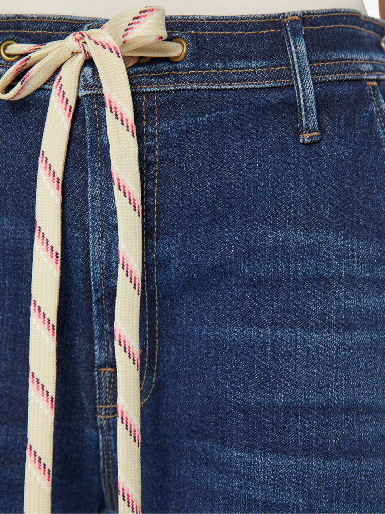 Swatch view of a woman in a dark blue high-rise wide leg with a drawstring waist, side-slit pockets and a long 32-inch inseam with a clean hem.