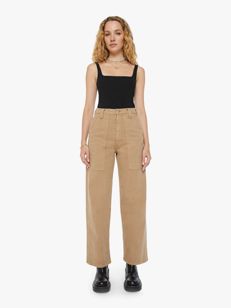 Front view of a woman super high-waisted pants with a wide straight leg, patch pockets and a long 31-inch inseam with a clean hem in a dark khaki.