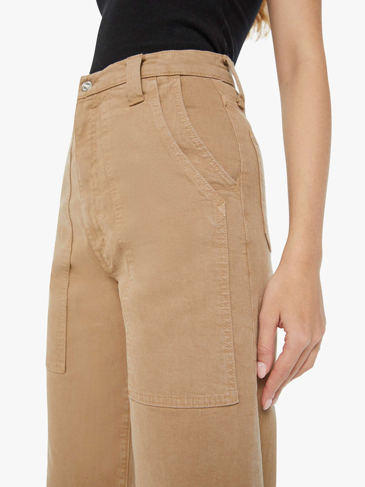 Close up view of a woman super high-waisted pants with a wide straight leg, patch pockets and a long 31-inch inseam with a clean hem in a dark khaki.