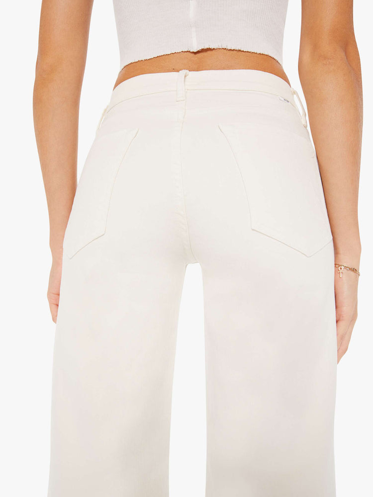 Back close up view of an ivory color pant featuring a high rise and wide leg.