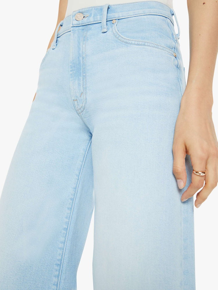 Close up view of a woman in a light blue super wide-leg jeans with a high rise, a slouchy fit and a long 32-inch inseam.