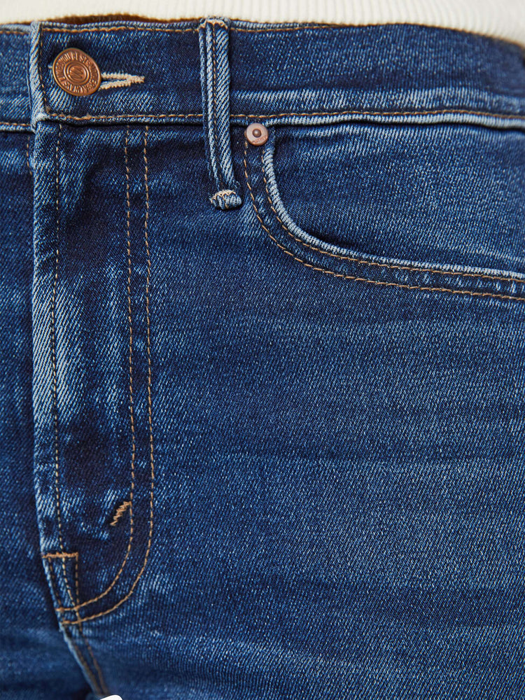 Detailed view of a woman in dark blue high-rise straight leg with a 32-inch inseam and a clean hem. 