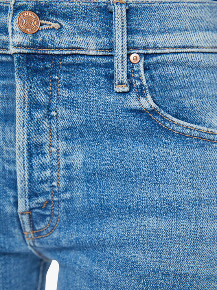 Swatch view of a woman in a mid blue slim straight-leg was adopted from our men’s line and features a mid rise, button fly, low-set back pockets and a clean hem. 