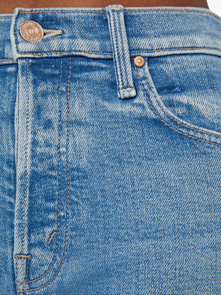 Swatch view of a woman in a light blue high-rise jean with a straight leg, button fly and a frayed hem.