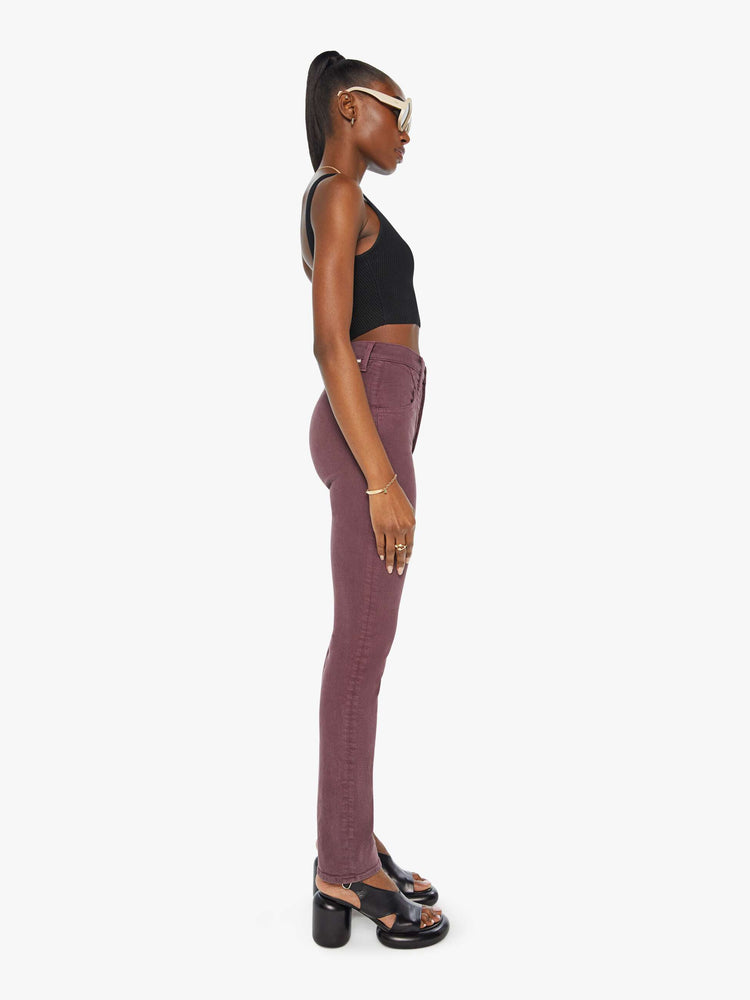 Side view of a woman in a maroon high-waisted skinny leg with a 31-inch inseam and a clean hem.