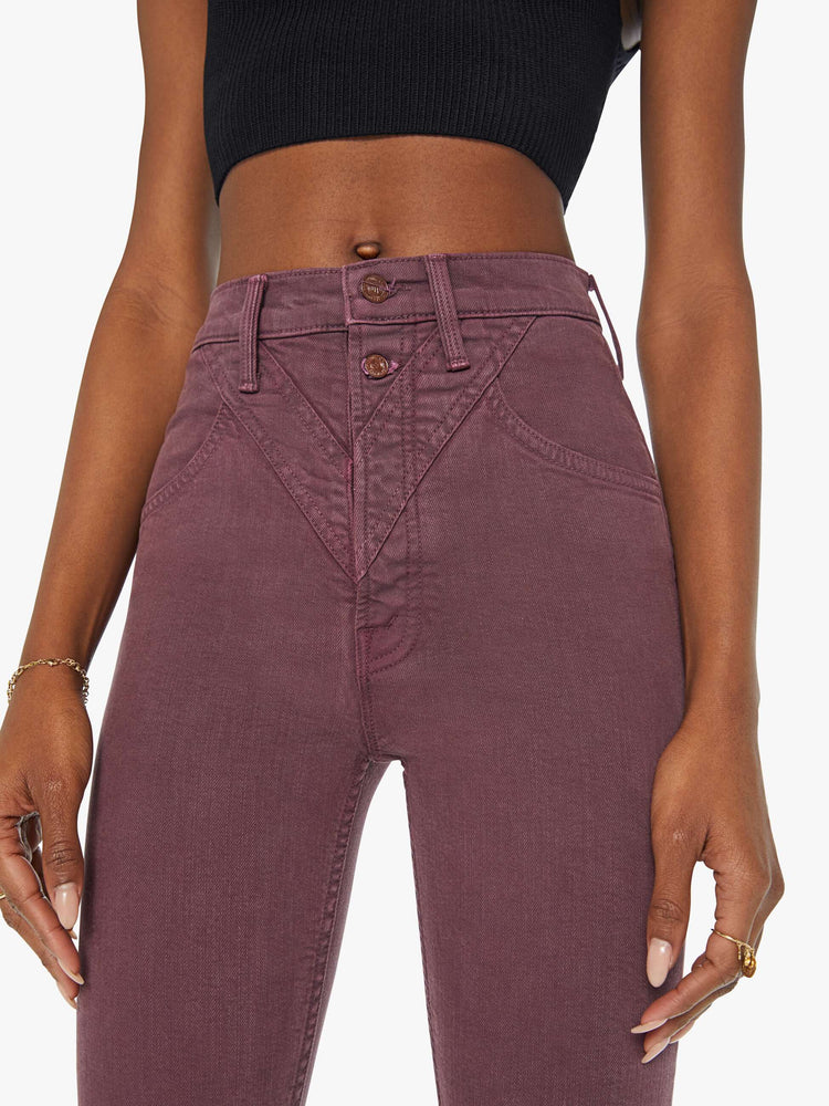 Close up view of a woman in a maroon high-waisted skinny leg with a 31-inch inseam and a clean hem.