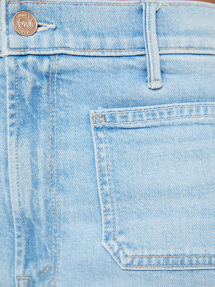 Swatch view of a woman in a light blue wash wide leg pants with a high rise, long 32-inch inseam and patch pockets. 