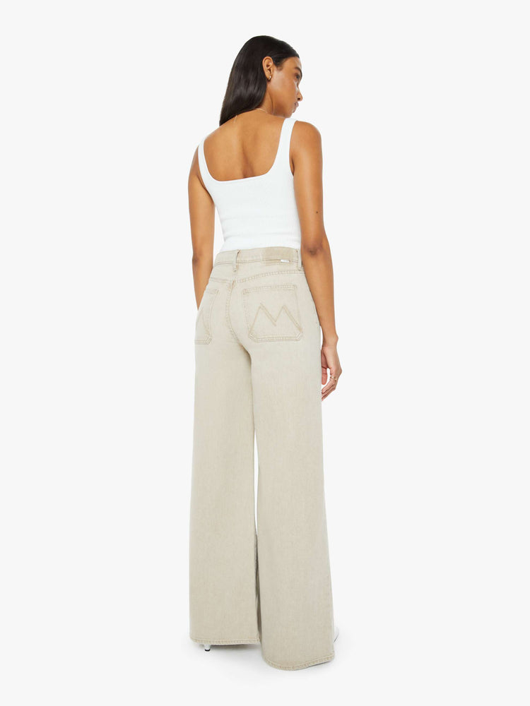 Back view of a woman in a light khaki wide leg pant with a high rise, long 32-inch inseam, patch pockets and a clean hem.