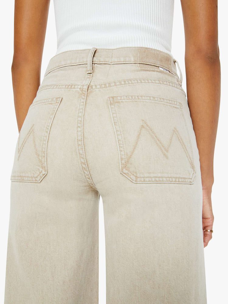 Back close up view of a woman in a light khaki wide leg pant with a high rise, long 32-inch inseam, patch pockets and a clean hem.