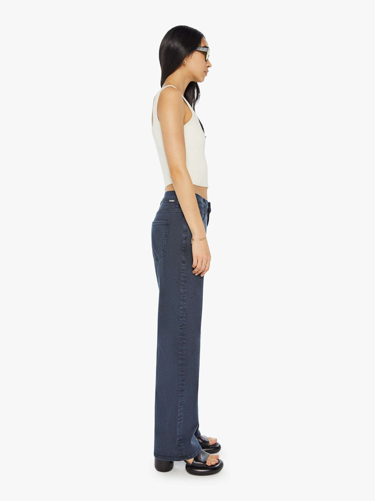 Side view of a woman in a faded black straight-leg jean with a long 32-inch inseam and a clean hem.