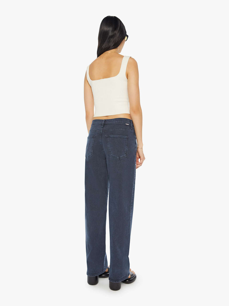 Back view of a woman in a faded black straight-leg jean with a long 32-inch inseam and a clean hem.