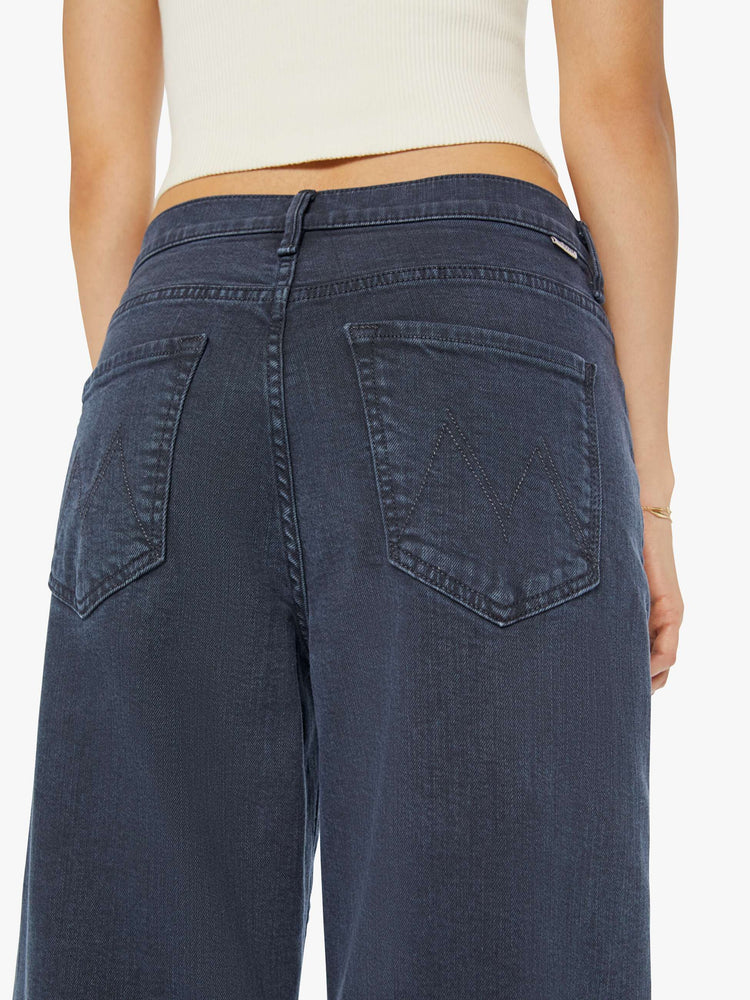 Close up view of a woman in a faded black straight-leg jean with a long 32-inch inseam and a clean hem.