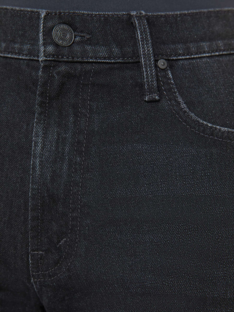 Swatch view of a woman in a black slouchy high-waisted jeans with a loose wide leg and a long 32-inch inseam with a clean hem.