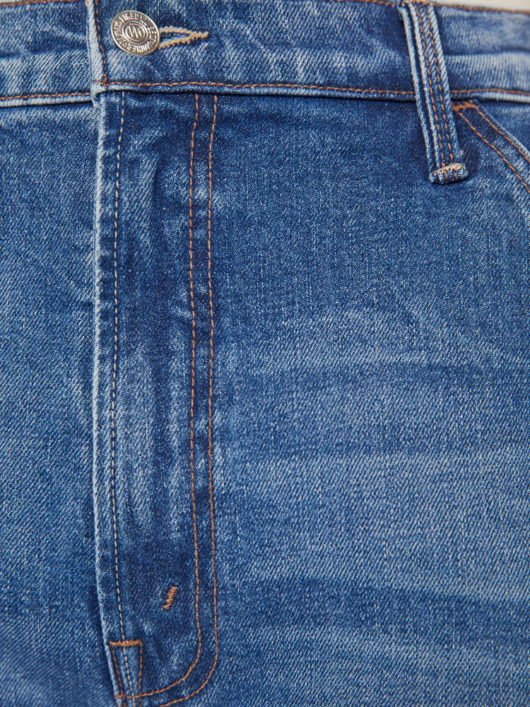 Swatch view of a woman in a mid blue super high waisted jean with a loose, straight leg, utility-inspired patch pockets, a hammer loop.